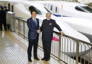 Indian Prime Minister Narendra Modi nd Japan's Prime Minister Shinzo Abe pose in front of Shinkansen bullet train before heading for Hyogo prefecture at Tokyo Station